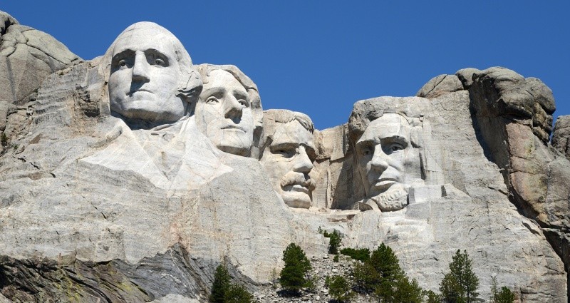 Mount Rushmore with four presidential faces carved in stone.